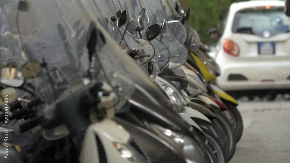 Scooter windshieds parked in a row Scooter windshieds parked in a row