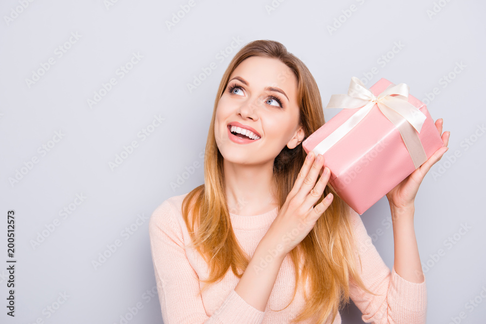 Rest relax chill blonde hair person people wonderment miracle concept. Close up portrait of astonished shocked amazed sweet girl trying to guess the present isolated on gray background copyspace Rest relax chill blonde hair person people wonderment miracle concept. Close up portrait of astonished shocked amazed sweet girl trying to guess the present isolated on gray background copyspace