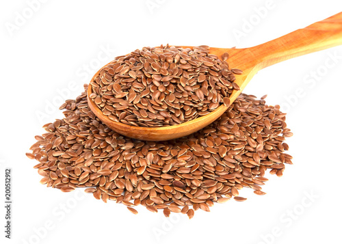 Flax seeds in wooden spoon isolated on white background