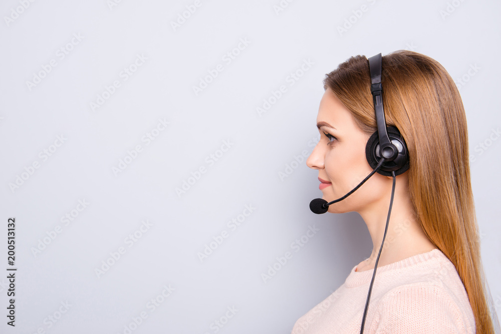 Blonde hair casual outfit clothes employment aid line helpdesk people profession person concept. Close up half-faced portrait of charming confident woman using headphones isolated on gray background Blonde hair casual outfit clothes employment aid line helpdesk people profession person concept. Close up half-faced portrait of charming confident woman using headphones isolated on gray background