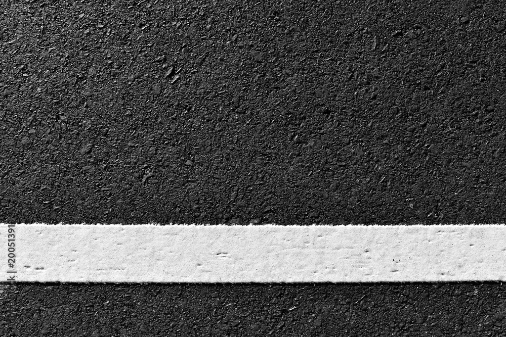 Fototapeta premium dirty white line on surface of old asphalt in countryside