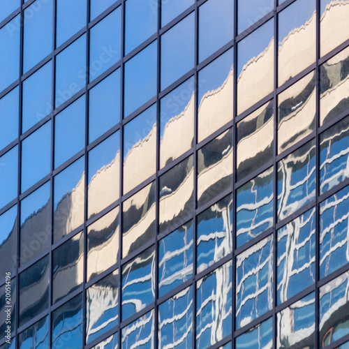 City landscape - view from below on glass skyscrapers with reflected sky in the windows, the city of Rotterdam, the Netherlands