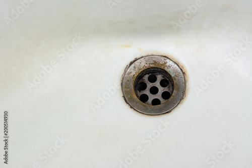 old and dirty wash basin drain outlet in bathroom. non hygienic household concept.