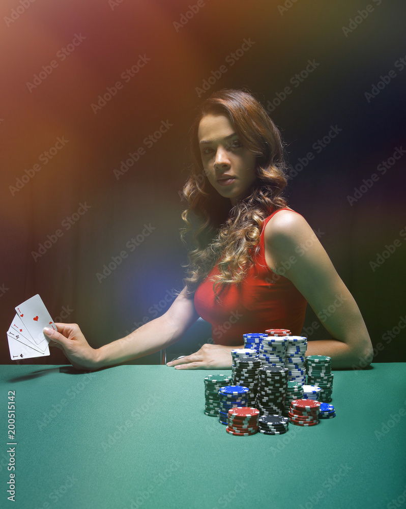 pretty young woman gambling on green table