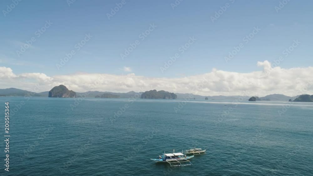 Pull down aerial shot of boats fishing in middle of sea near Lagen Island, Philippines Pull down aerial shot of boats fishing in middle of sea near Lagen Island, Philippines