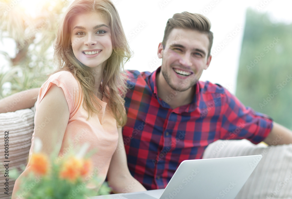 young man and girl sitting in front of an open laptop young man and girl sitting in front of an open laptop