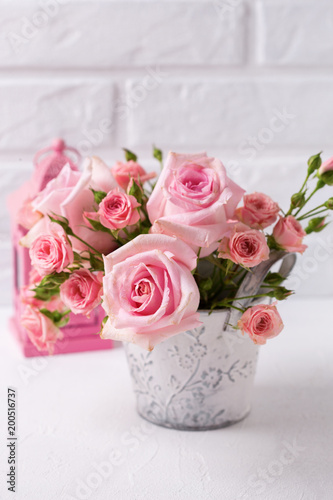 Bunch of tender pink roses flowers and decorative pink lantern