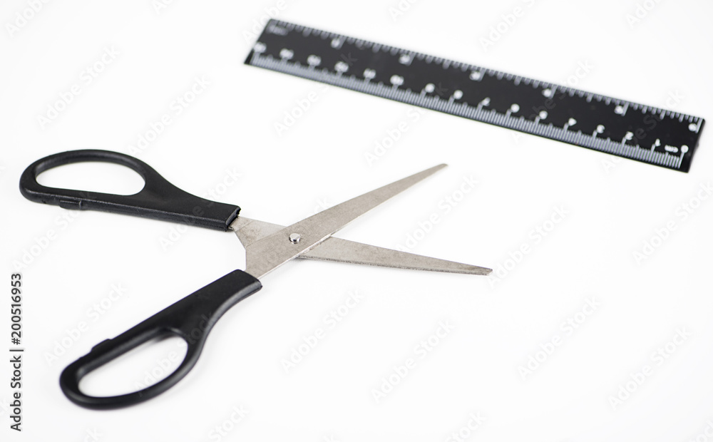 Scissors and measuring ruler on white background. Stationery. Workplace. Scissors and measuring ruler on white background. Stationery. Workplace.