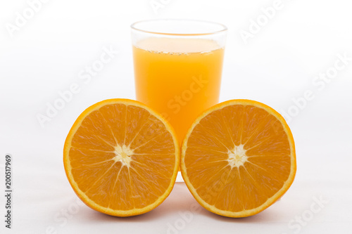 Orange cut on white background and orange juice in glass