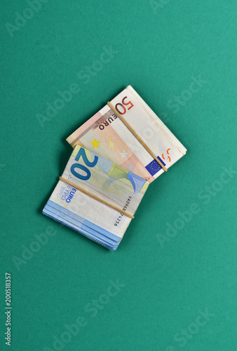 bent banknotes on green background