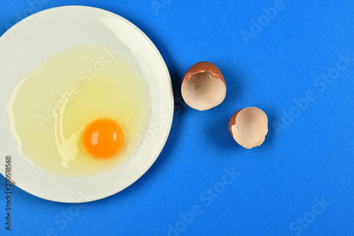 cracked egg on blue background photo