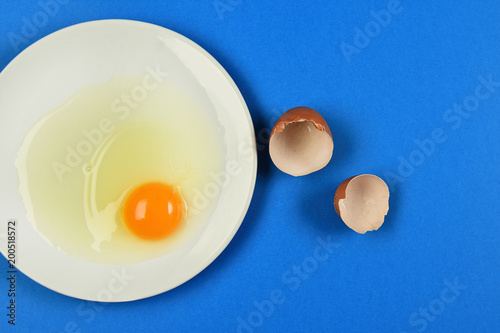 cracked egg on blue background photo