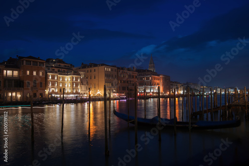 Night in Venice  gondolas on the Grand Canal in the background illuminated buildings and waterfront