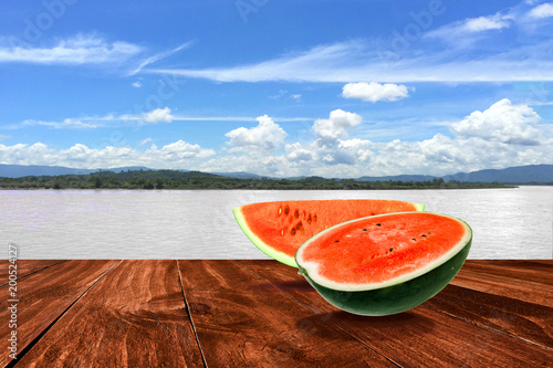 water melons slice  on dark wood and river view
