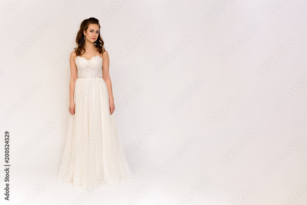beautiful bride in white wedding dress in different poses on white backgrounds shows different emotions beautiful bride in white wedding dress in different poses on white backgrounds shows different emotions