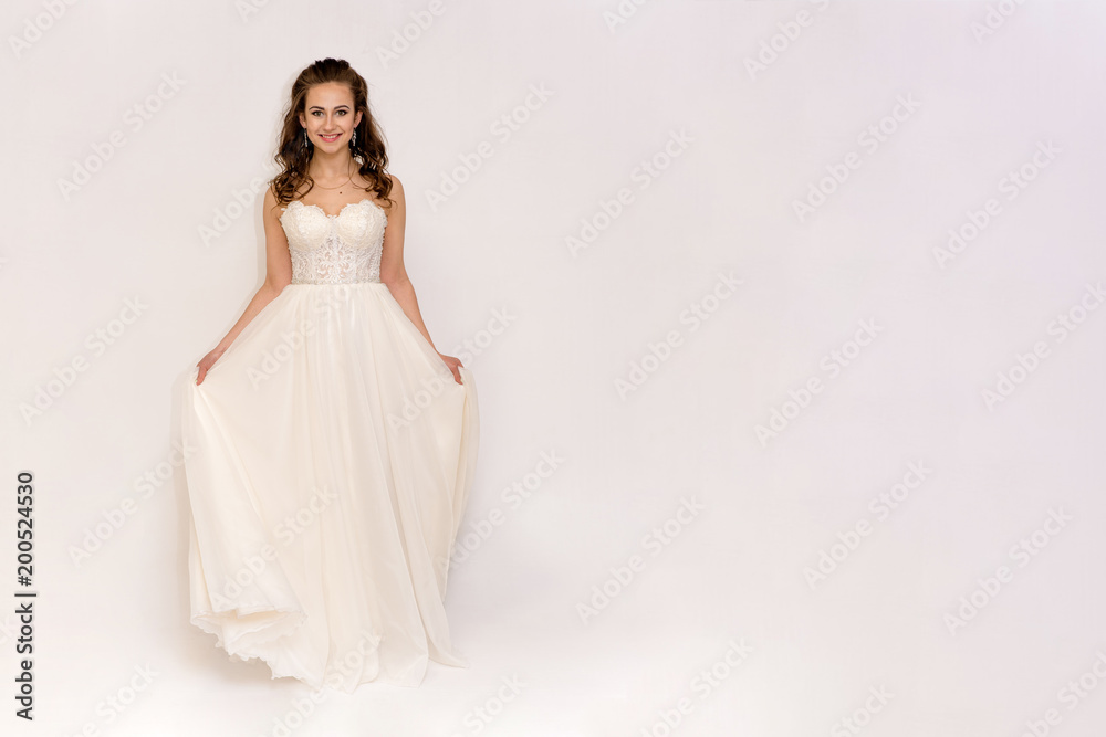 beautiful bride in white wedding dress in different poses on white backgrounds shows different emotions beautiful bride in white wedding dress in different poses on white backgrounds shows different emotions