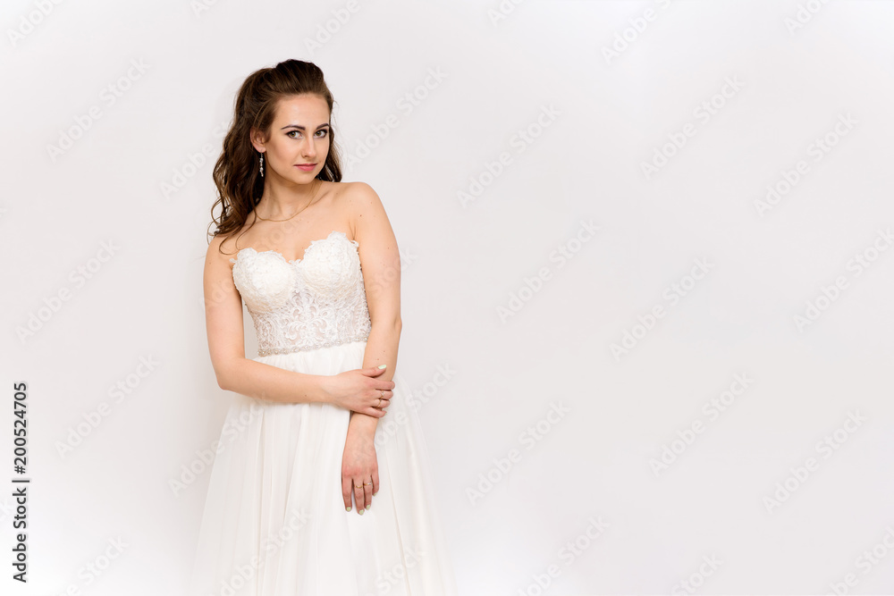 beautiful bride in white wedding dress in different poses on white backgrounds shows different emotions beautiful bride in white wedding dress in different poses on white backgrounds shows different emotions
