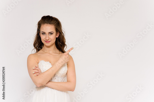 beautiful bride in white wedding dress in different poses on white backgrounds shows different emotions