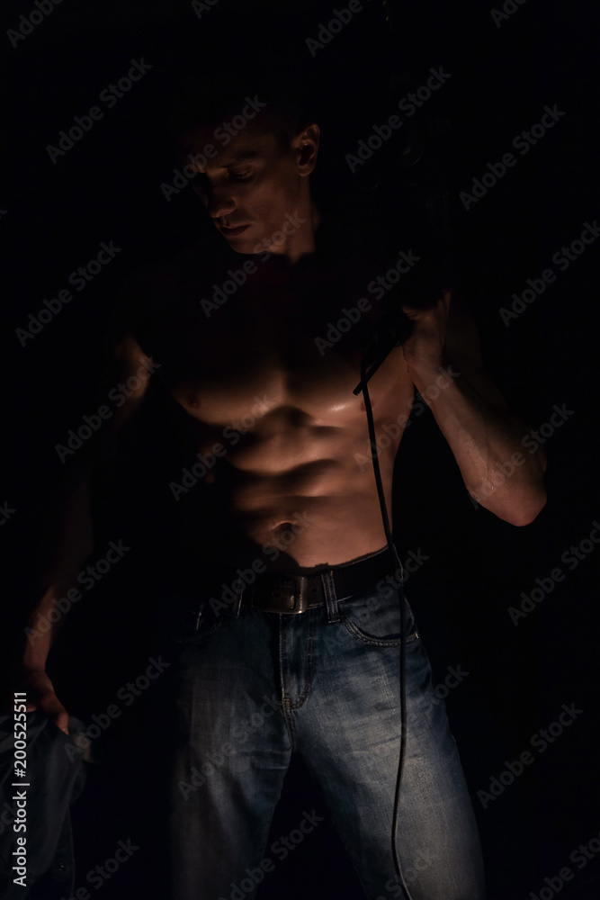 Fototapeta premium Tired man with a drill, muscular man, the embodiment of masculinity