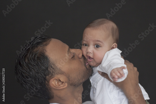 Father and daughter on black background 