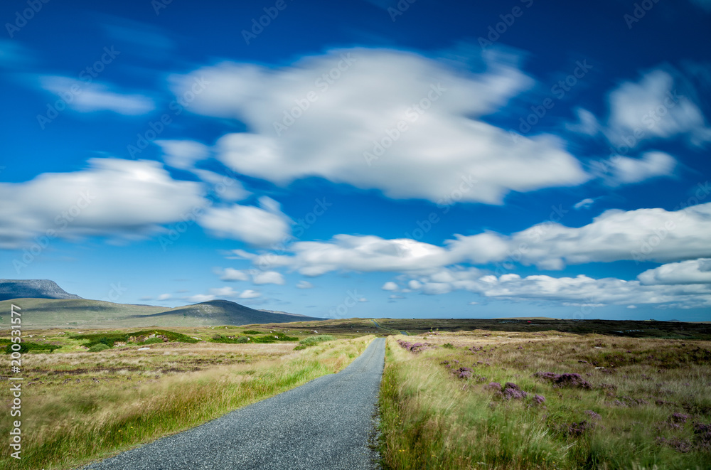 Road immersed in the peat bogs that together with the celo characterize the Irish landscape Donegal Ireland