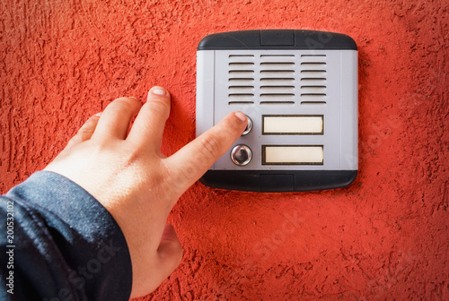 hand ringing on doorbell photo