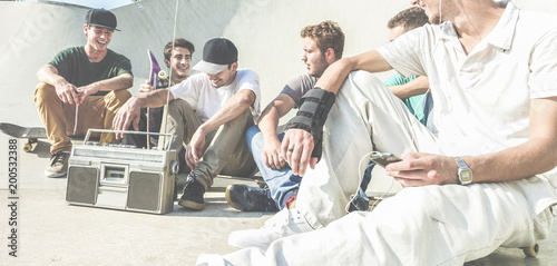 Young friends having fun at city skateboard pubblic park