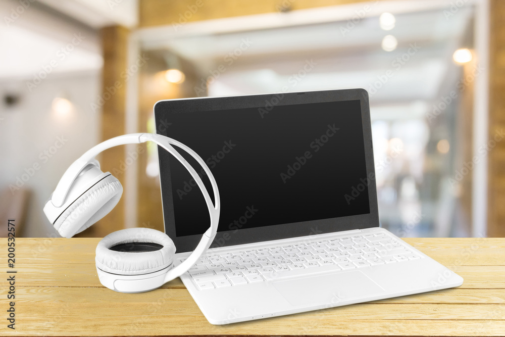 Fototapeta premium Headphones with laptop on table