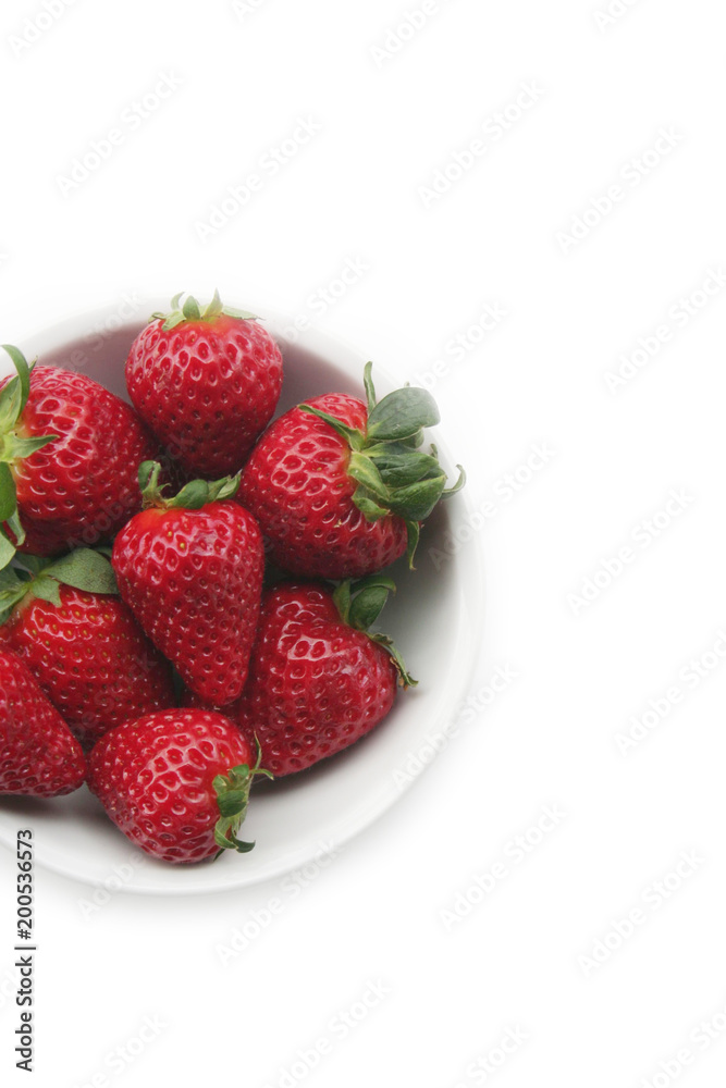 Fresh strawberries in a bowl isolated on white background