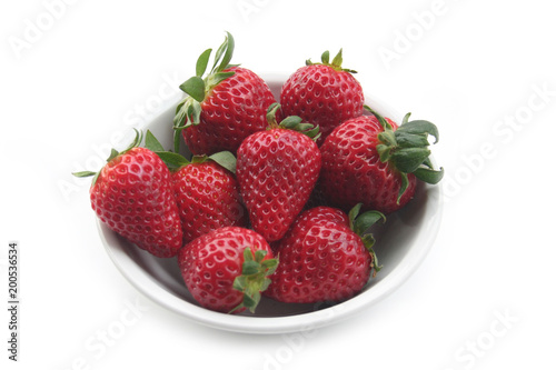 Fresh strawberries in a bowl isolated on white background