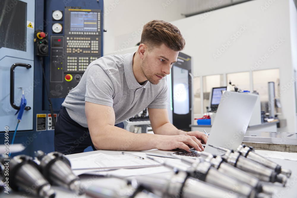 Male Engineer Using CAD Programming Software On Laptop
