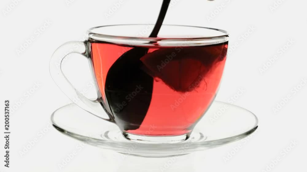 Spoonful sugar thrown into cup of fruit tea and stir Spoonful sugar thrown into cup of fruit tea and stir