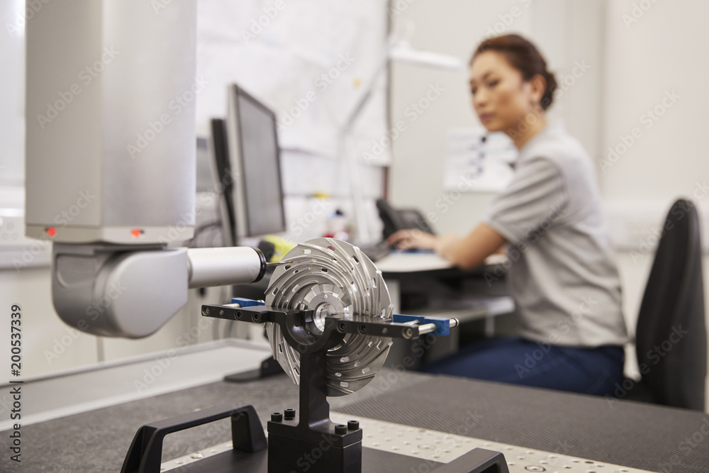Fototapeta premium Female Engineer Uses CMM Coordinate Measuring Machine In Factory