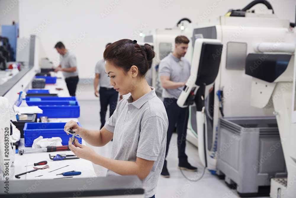 Female Engineer Quality Controlling Components In Factory Female Engineer Quality Controlling Components In Factory