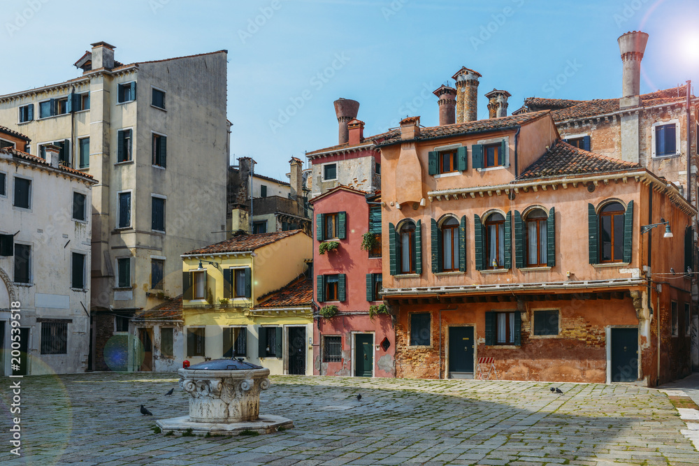 Colourful and historic houses at the Campo della Maddalena in Venice, Italy, with a variety of shapes and sizes in the local architecturural style.