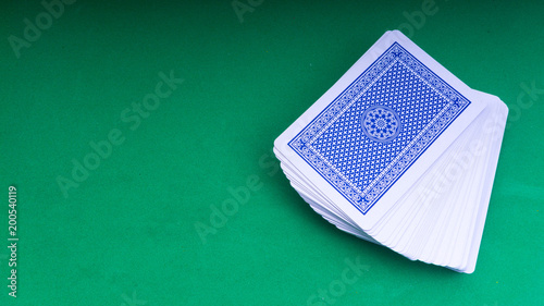 Closeup of playing cards isolated with a green background.