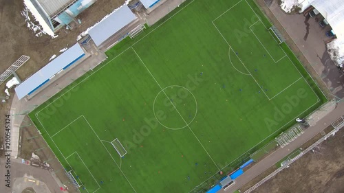 Aerial view of district soccer field with players training on grass