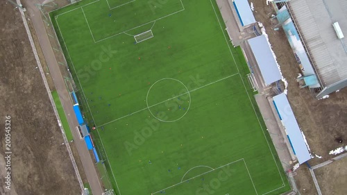 Aerial view of district soccer field with players training on grass
