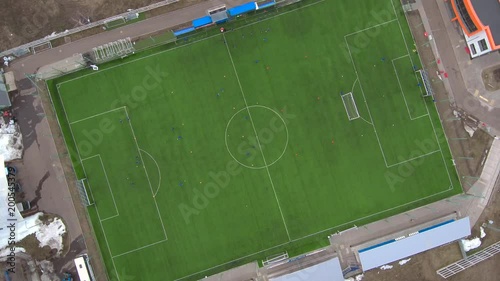 Aerial view of district soccer field with players training on grass