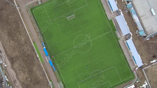 Aerial view of district soccer field with players training on grass