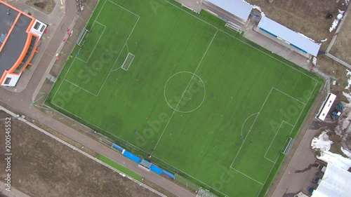 Aerial view of district soccer field with players training on grass