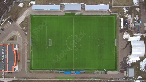 Aerial view of district soccer field with players training on grass