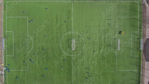 Aerial view of district soccer field with players training on grass