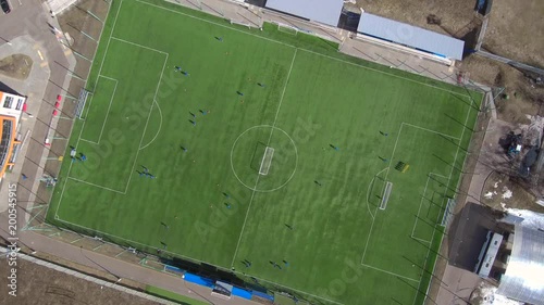 Aerial view of district soccer field with players training on grass