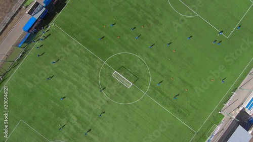 Aerial view of district soccer field with players training on grass