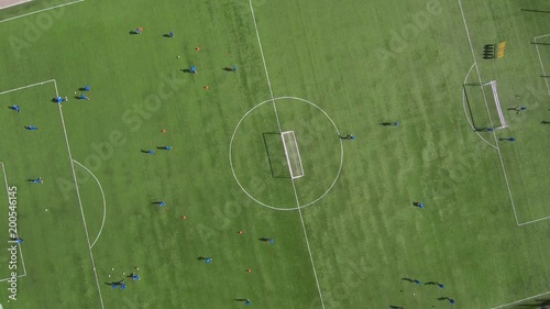 Aerial view of district soccer field with players training on grass