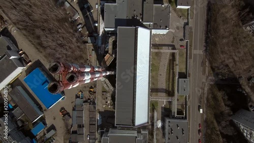 Smoking pipes in industrial zone of the city near residential area. Fly from above