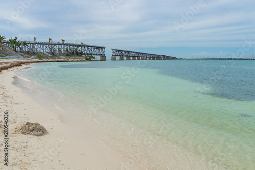 USA, Florida, Ancient overseas railway bridge ruins in tropical clear water at beach © Simon