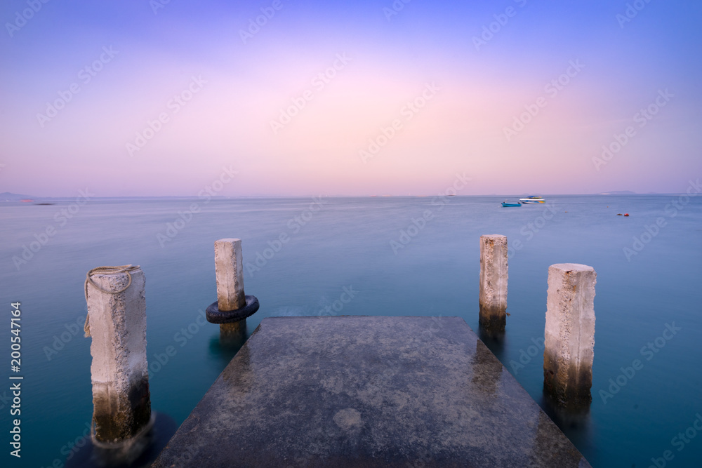 old empty cement dock in sea with sunset twilight time