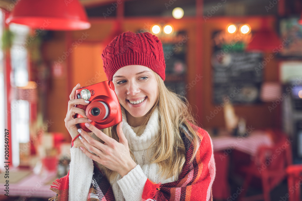 Smiling attractive woman with a red polaroid Smiling attractive woman with a red polaroid